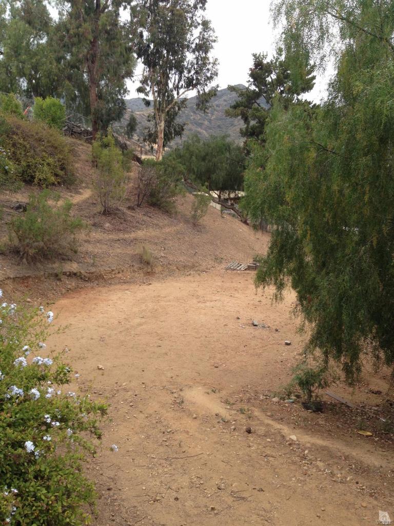 192 Wrangler Road Simi Valley, CA 93065 - Photo 37 of 40 a view of a dirt yard with trees