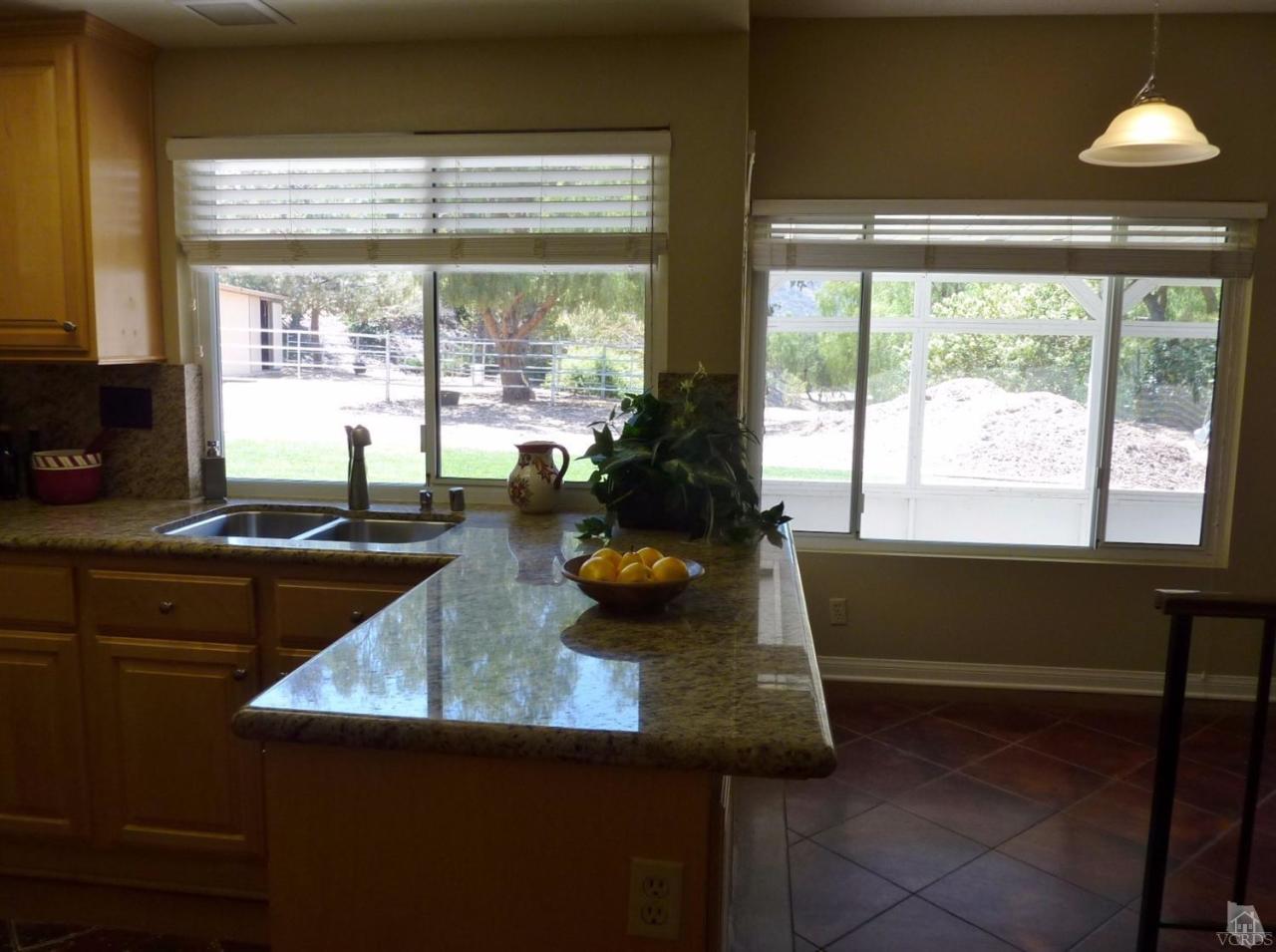 192 Wrangler Road Simi Valley, CA 93065 - Photo 9 of 40 a kitchen with granite countertop sink and window