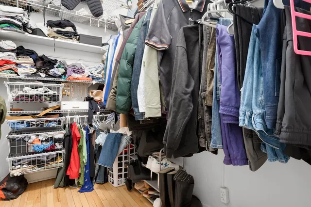 a view of walk in closet with clothes and shoes