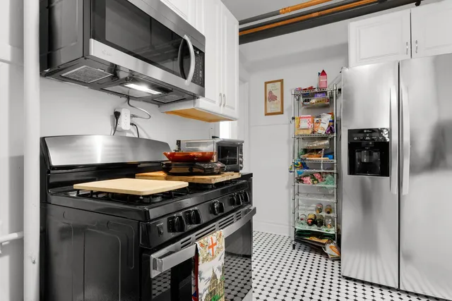 a kitchen with stainless steel appliances granite countertop a stove and a refrigerator