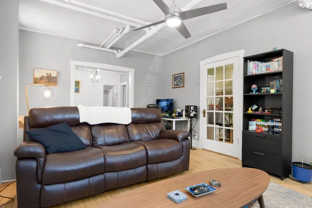 a living room with furniture a rug and a window