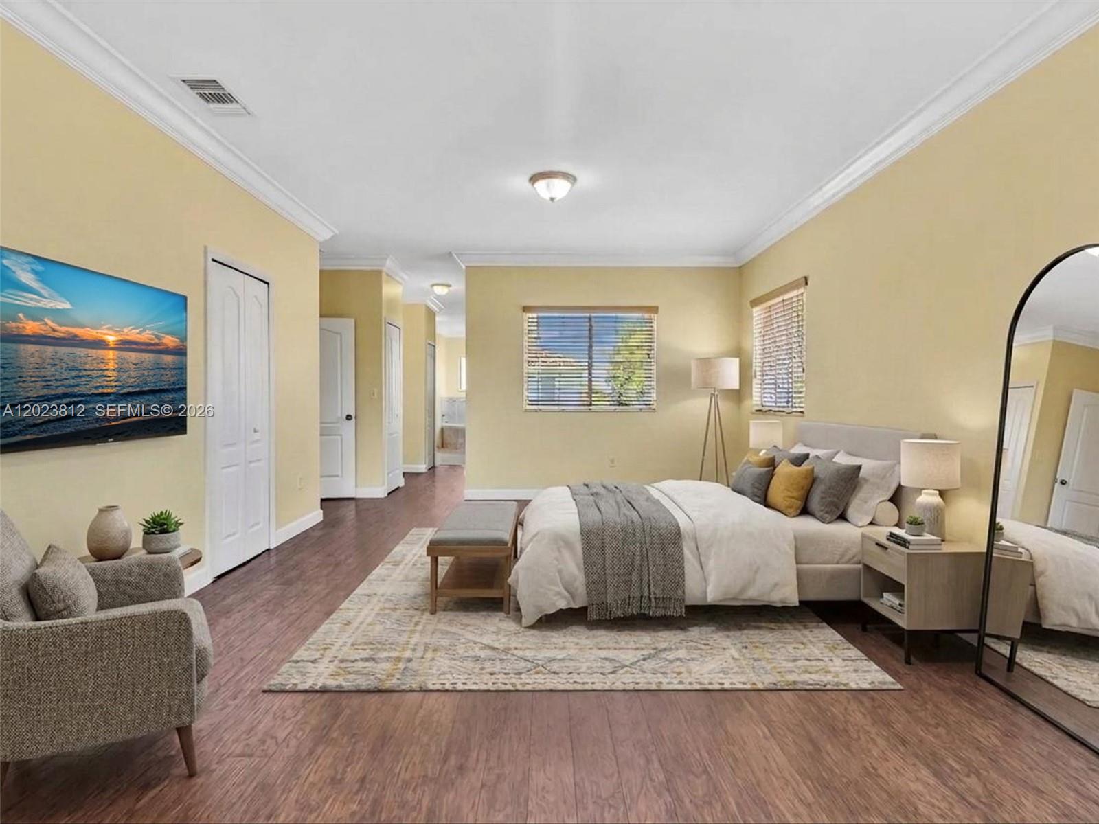 2864 Southwest 138th Path Miami, FL 33175 - Photo 20 of 40 a spacious bedroom with a bed a couch and a flat screen tv