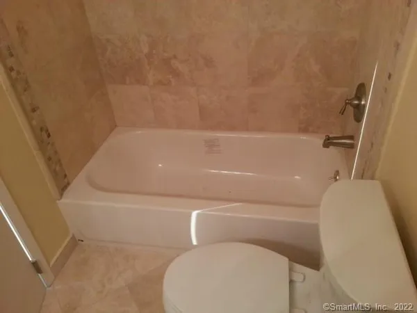 a bathroom with a toilet and bathtub