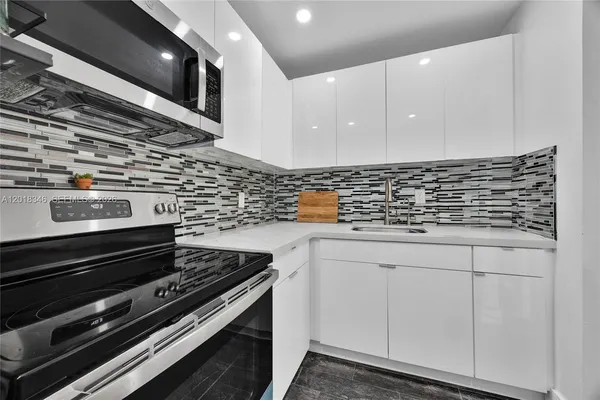 a stove top oven sitting inside of a kitchen