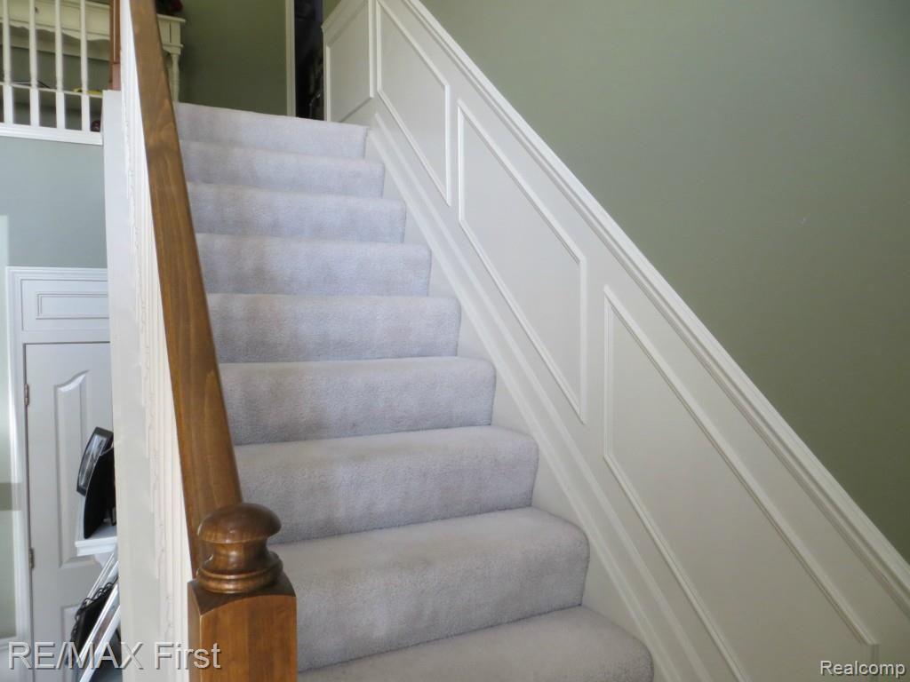 1341 Copper Circle, Unit 33 Rochester, MI 48306 - Photo 24 of 37 Stairs to upper level with beautiful wainscoting