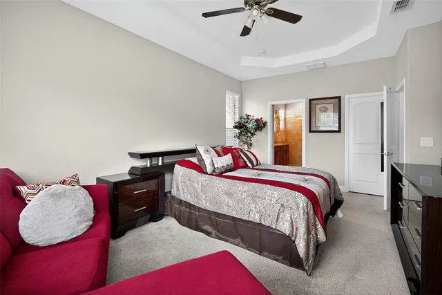 a bedroom with bed and a chandelier