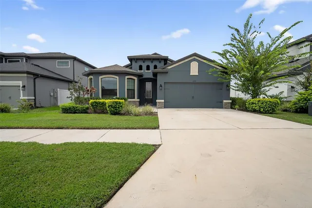 a front view of house with yard and green space