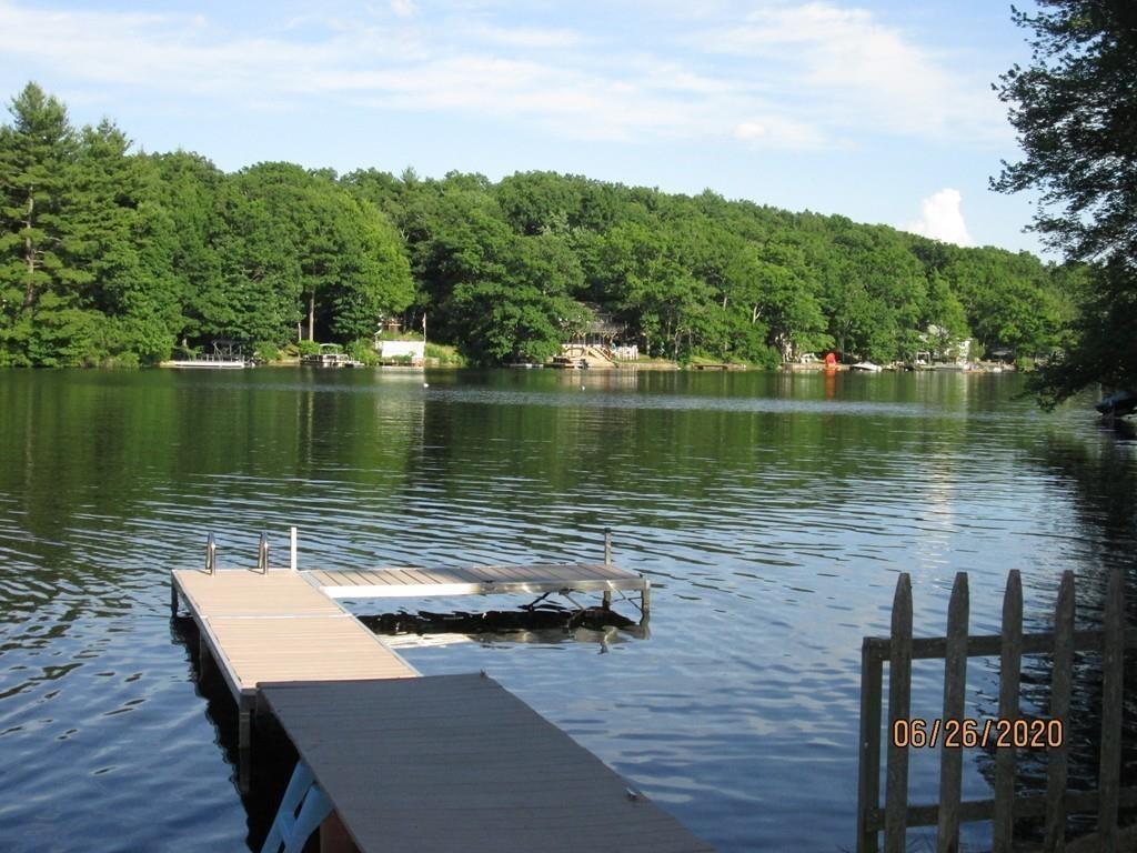 44 Ridge Trail Douglas, MA 01516 - Photo 11 of 22 a view of a lake with a bench next to a lake