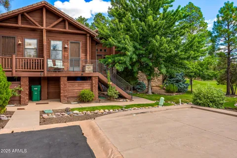 a front view of a house with a yard and potted plants