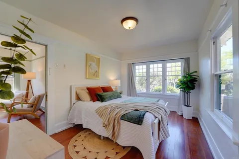 a bed sitting in a bedroom next to a window