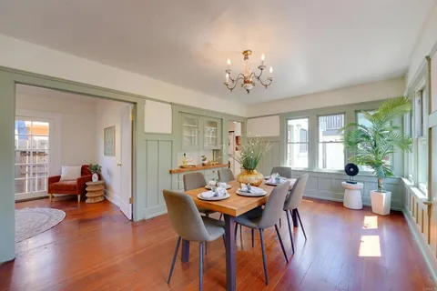 a view of a dining room with furniture window and wooden floor