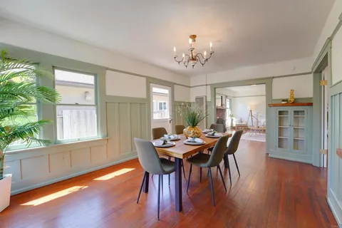 a view of a dining room with furniture window and wooden floor
