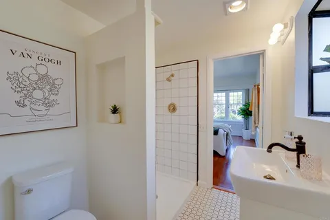 a large white kitchen with stainless steel appliances granite countertop a sink and cabinets