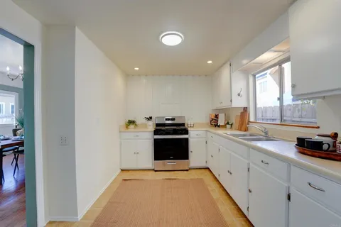 a kitchen with cabinets a washer and dryer