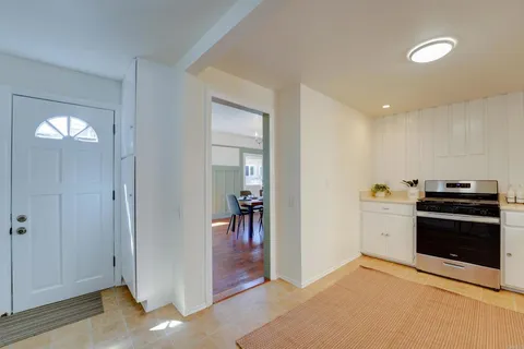 a kitchen with cabinets and washer dryer