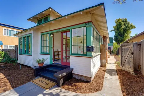 a view of a house with a door and a yard