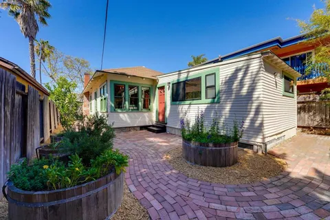 a view of a house with wooden deck