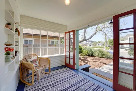 a living room filled with furniture and a floor to ceiling window