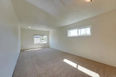 a view of a hallway with chandelier and entryway