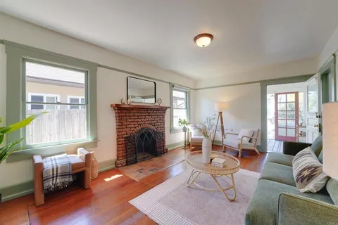 a living room with furniture fireplace and window