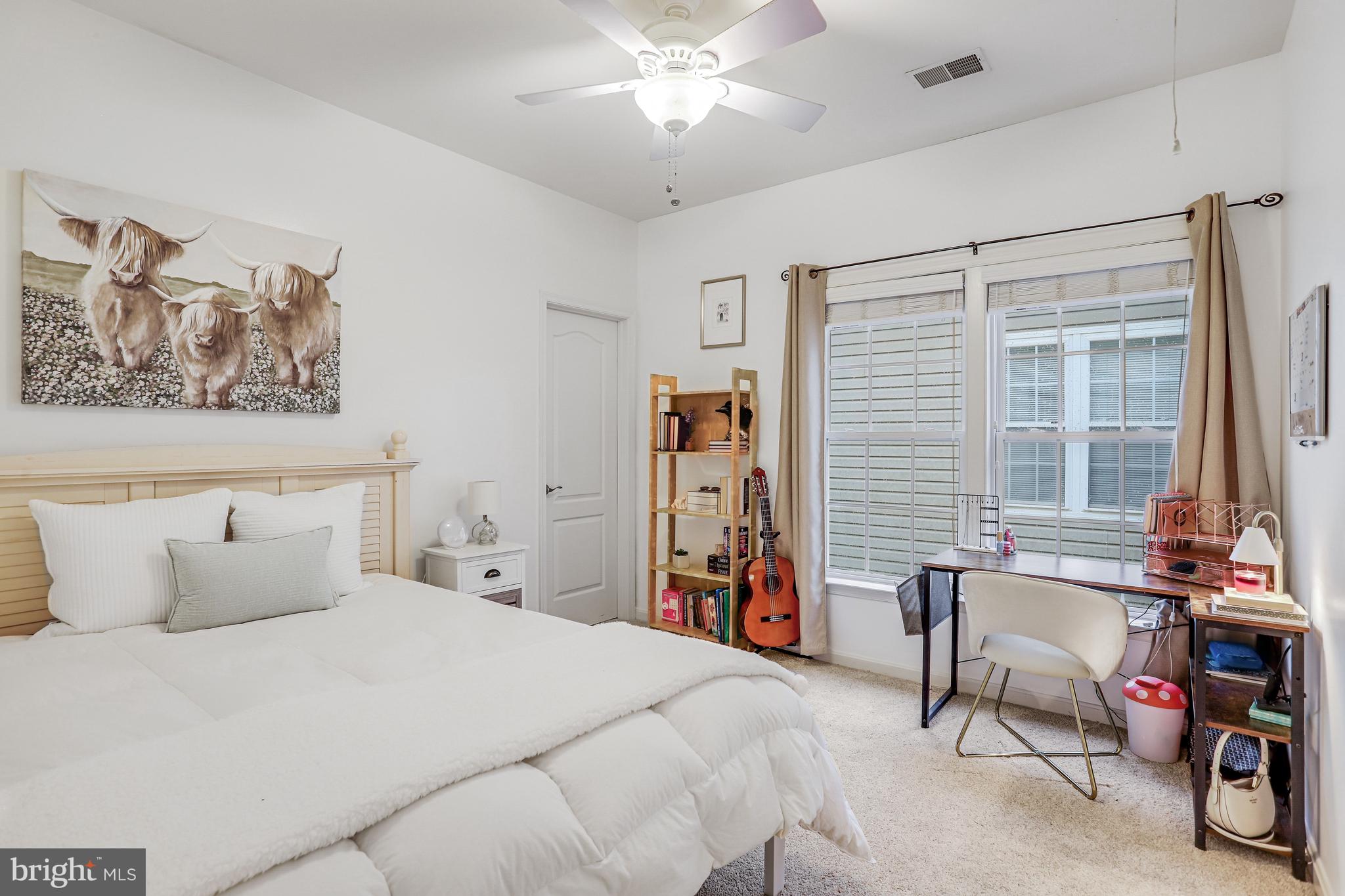 21625 Merion Street Ashburn, VA 20147 - Photo 13 of 80 a bedroom with a bed and a chandelier
