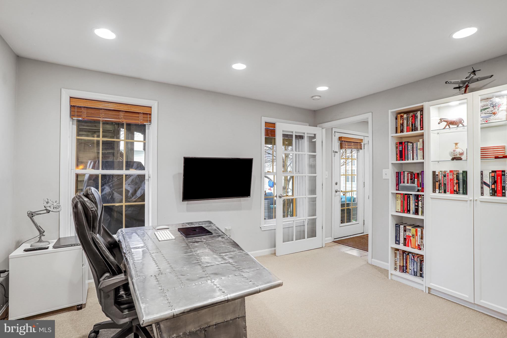21625 Merion Street Ashburn, VA 20147 - Photo 18 of 80 a view of a livingroom with workspace and a flat screen tv