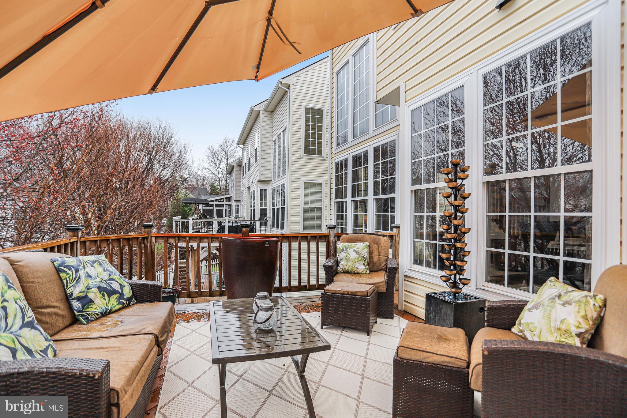 21625 Merion Street Ashburn, VA 20147 - Photo 19 of 80 a view of a patio with couches chairs and wooden floor