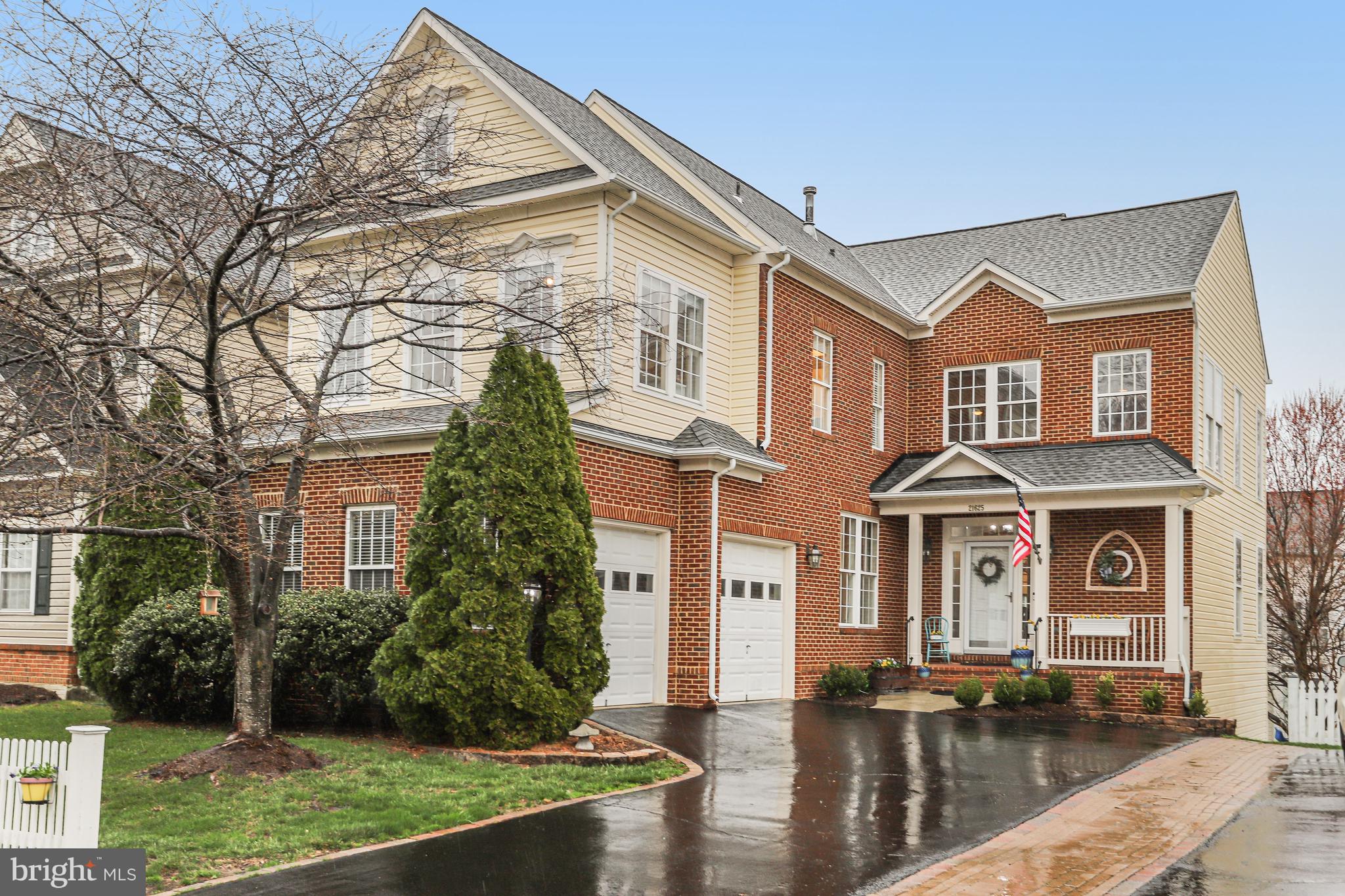 21625 Merion Street Ashburn, VA 20147 - Photo 2 of 80 front view of a brick house with a yard
