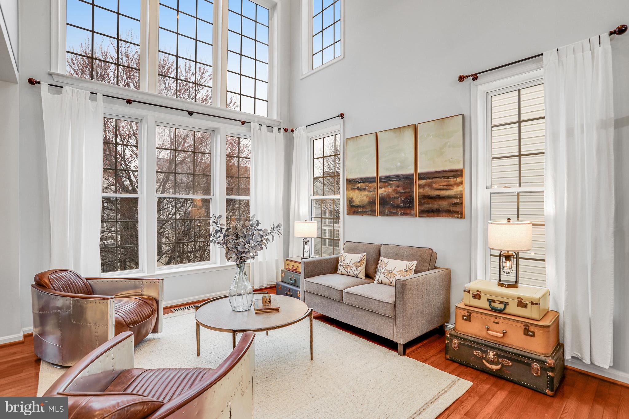 21625 Merion Street Ashburn, VA 20147 - Photo 3 of 80 a living room with furniture and floor to ceiling windows