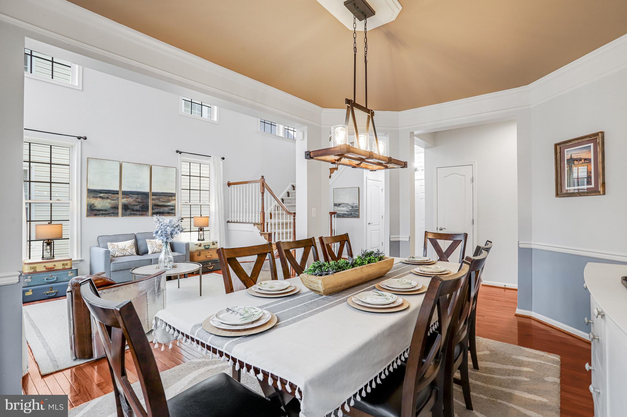 21625 Merion Street Ashburn, VA 20147 - Photo 32 of 80 a view of a dining room and livingroom view with furniture wooden floor chandelier