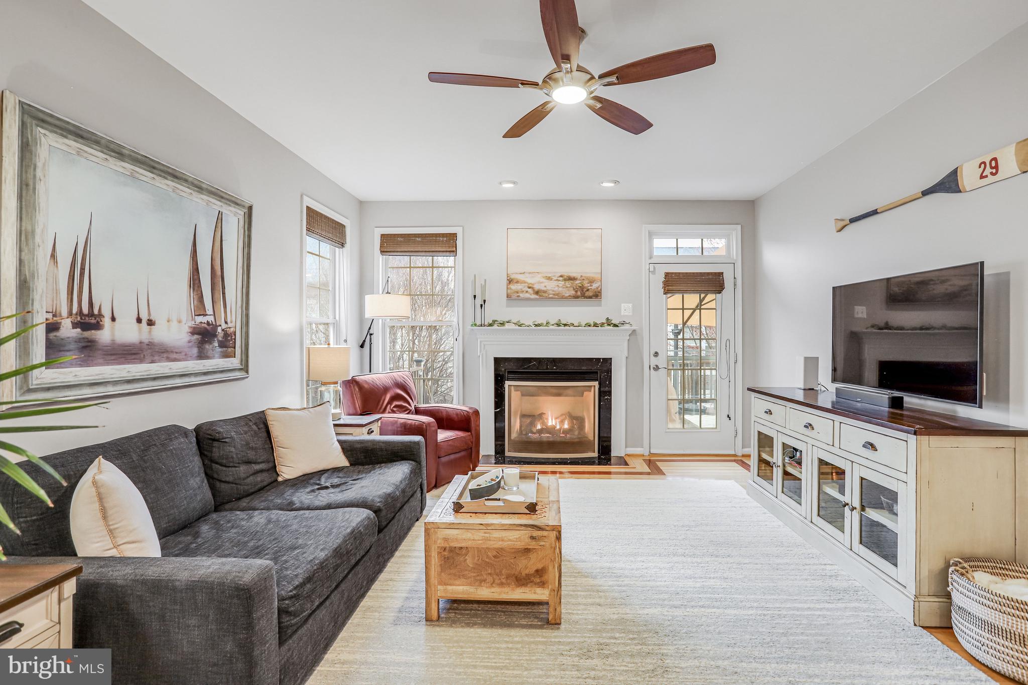 21625 Merion Street Ashburn, VA 20147 - Photo 35 of 80 a living room with furniture and a flat screen tv