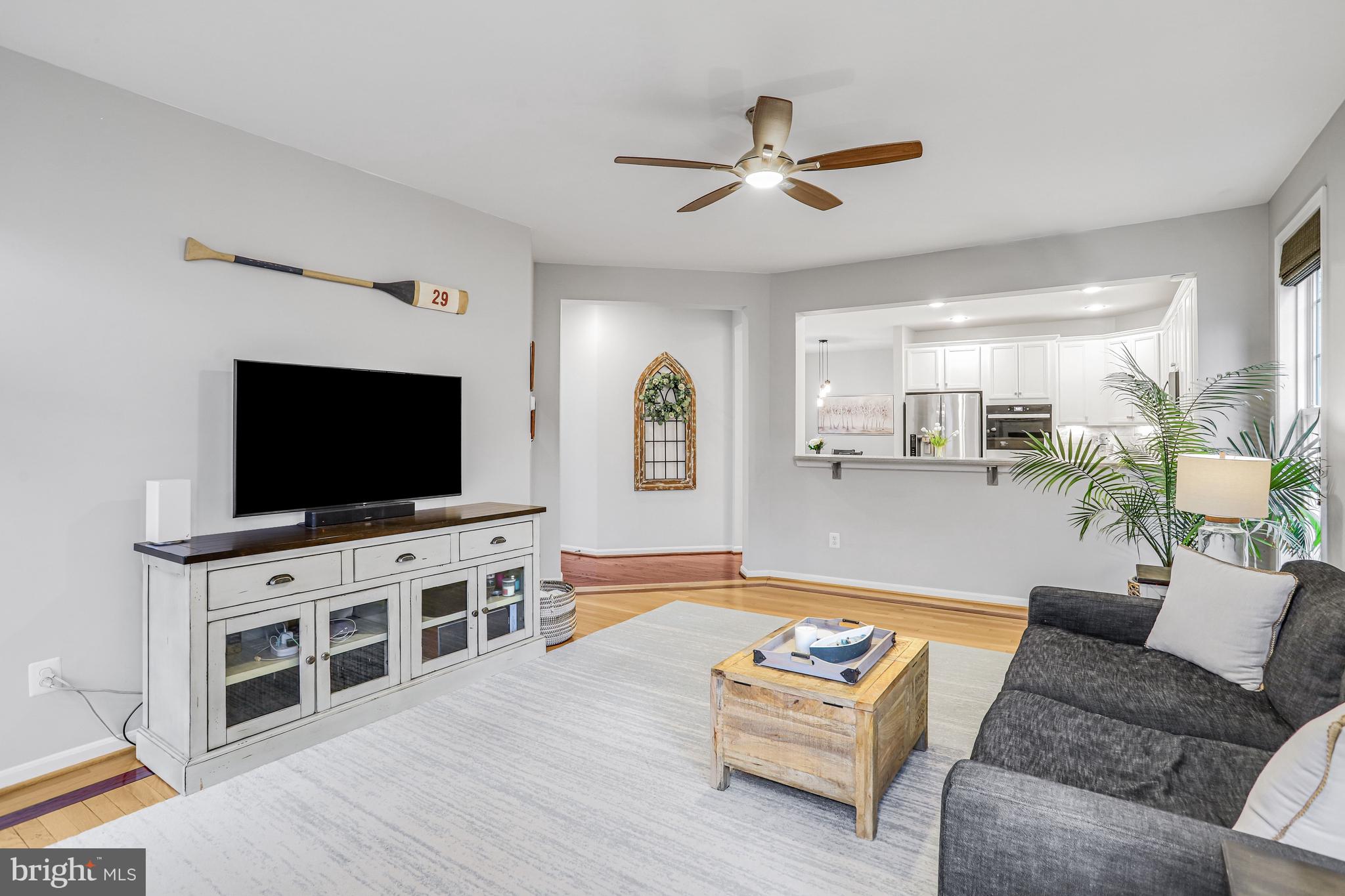 21625 Merion Street Ashburn, VA 20147 - Photo 36 of 80 a living room with furniture and a flat screen tv
