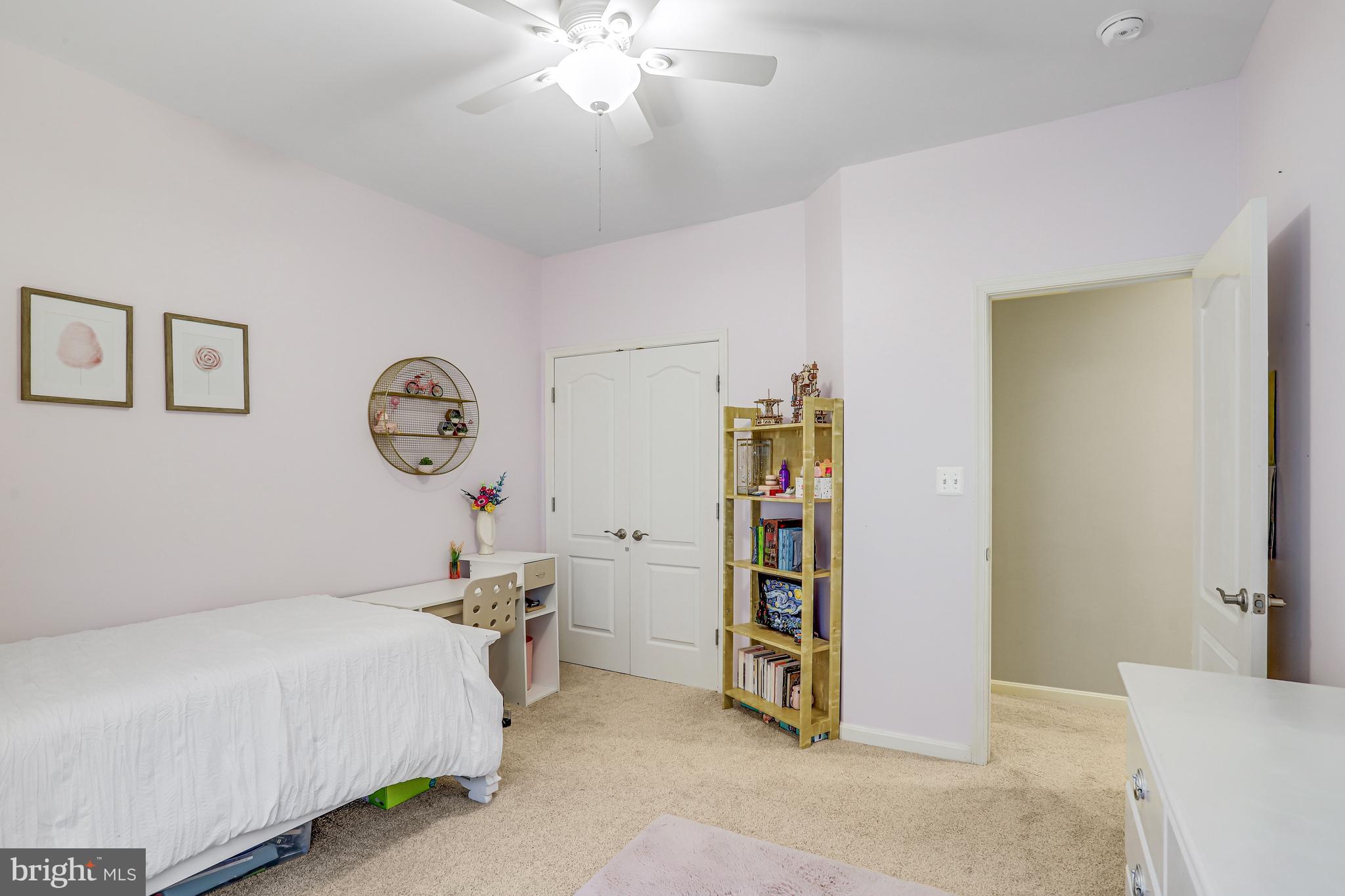 21625 Merion Street Ashburn, VA 20147 - Photo 57 of 80 a bed room with a bed and a chandelier