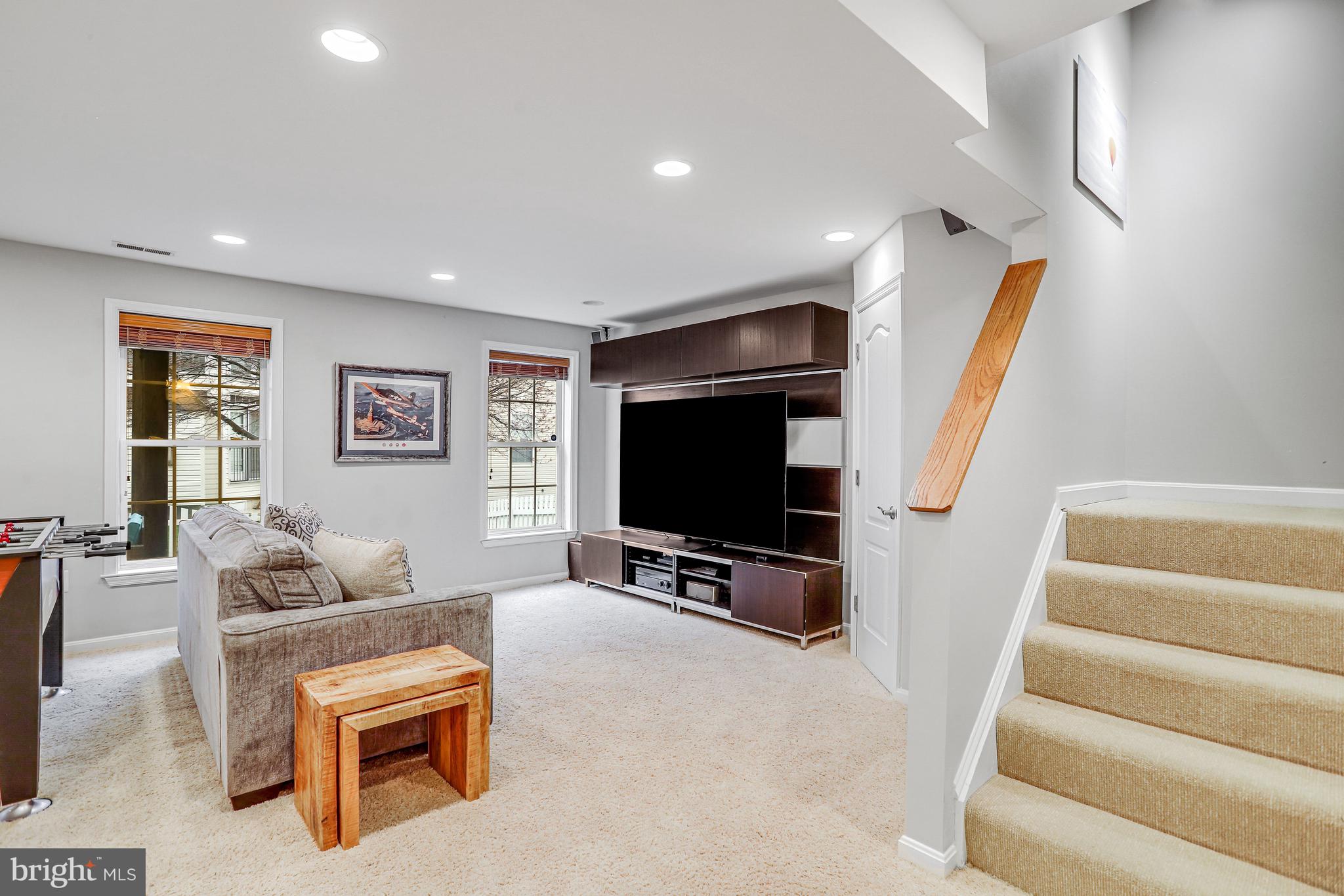 21625 Merion Street Ashburn, VA 20147 - Photo 61 of 80 a living room with furniture and a flat screen tv
