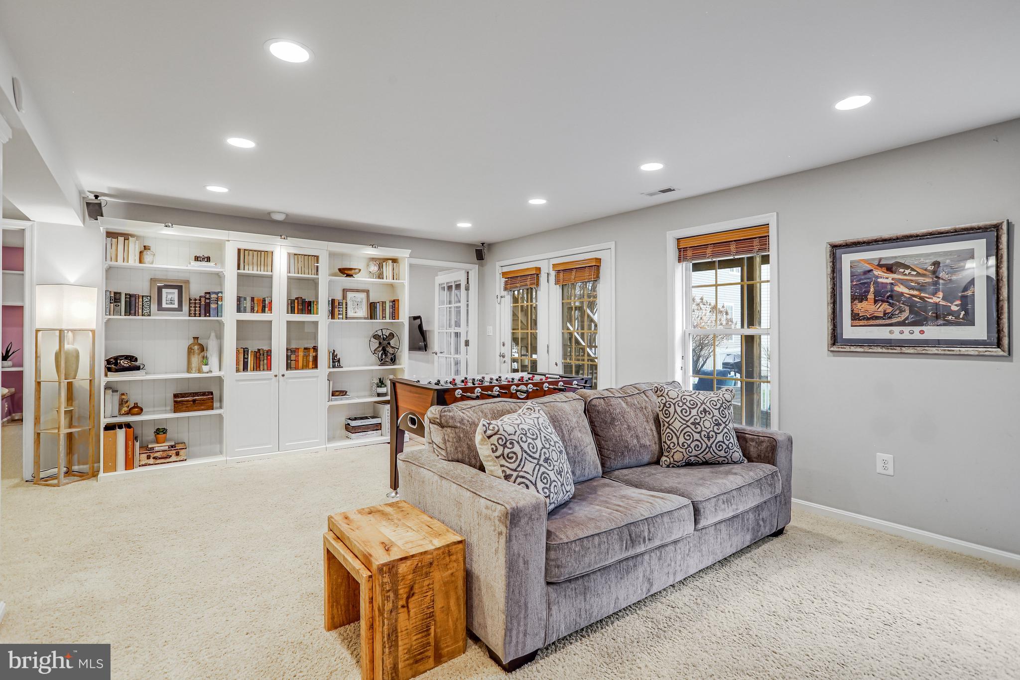 21625 Merion Street Ashburn, VA 20147 - Photo 62 of 80 a living room with furniture and a flat screen tv