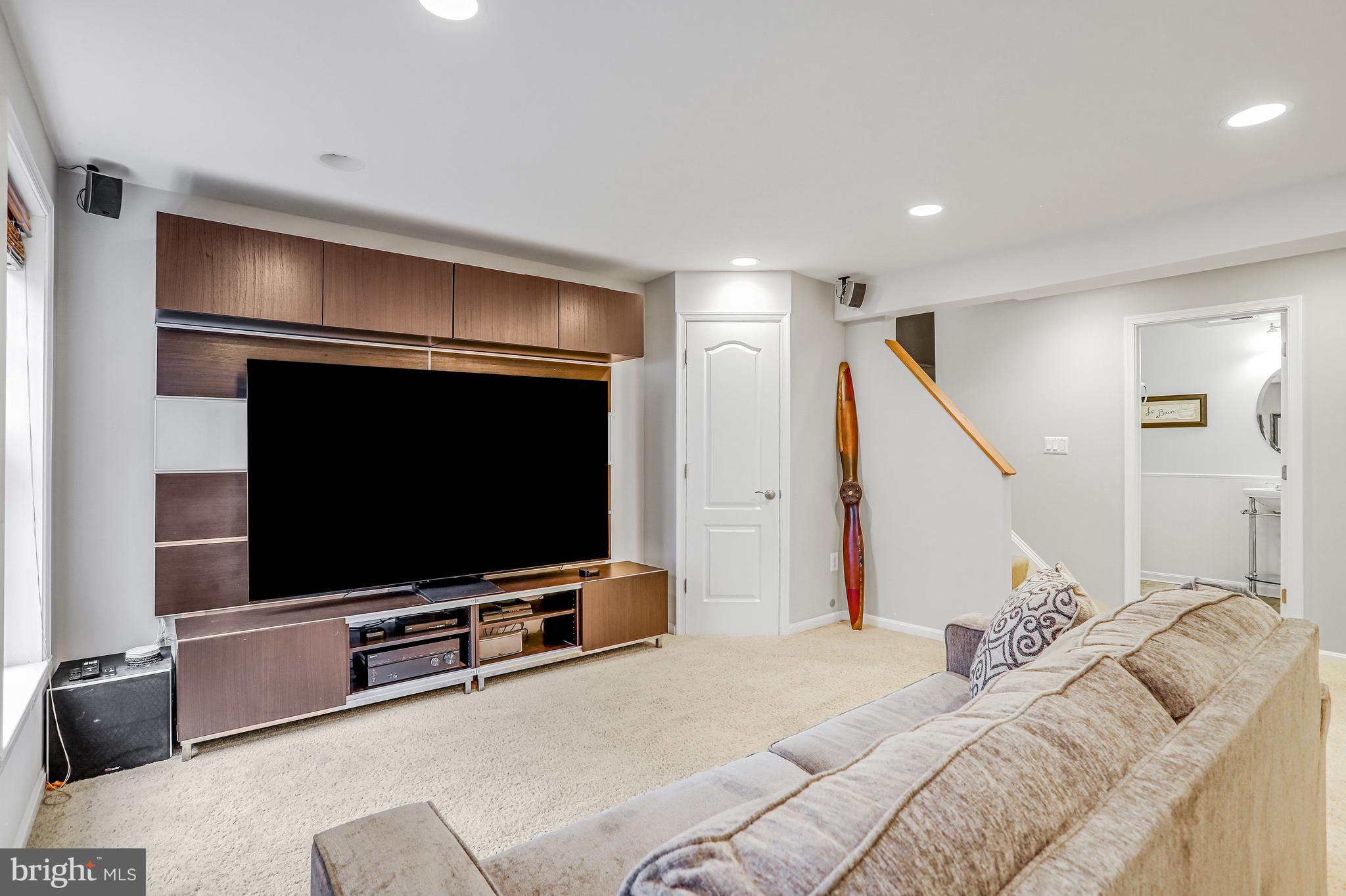 21625 Merion Street Ashburn, VA 20147 - Photo 63 of 80 a living room with furniture and a flat screen tv