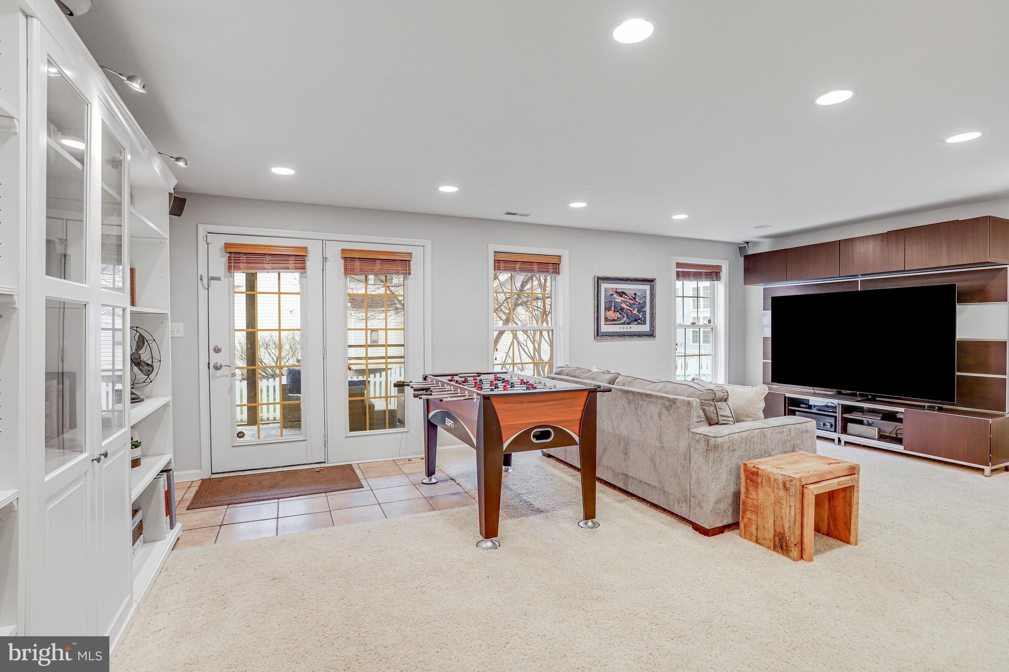 21625 Merion Street Ashburn, VA 20147 - Photo 65 of 80 a living room with furniture and a flat screen tv