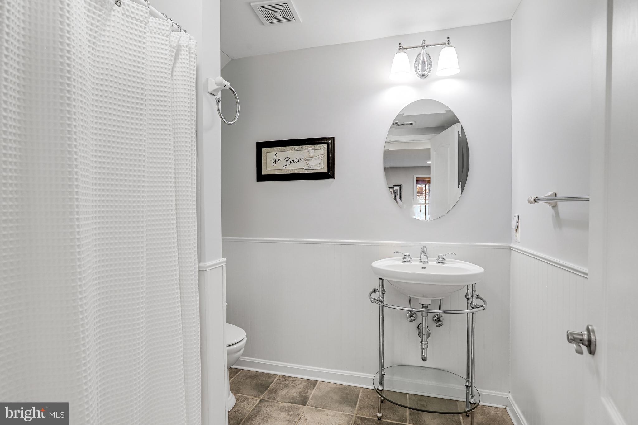 21625 Merion Street Ashburn, VA 20147 - Photo 73 of 80 a bathroom with a toilet sink and mirror