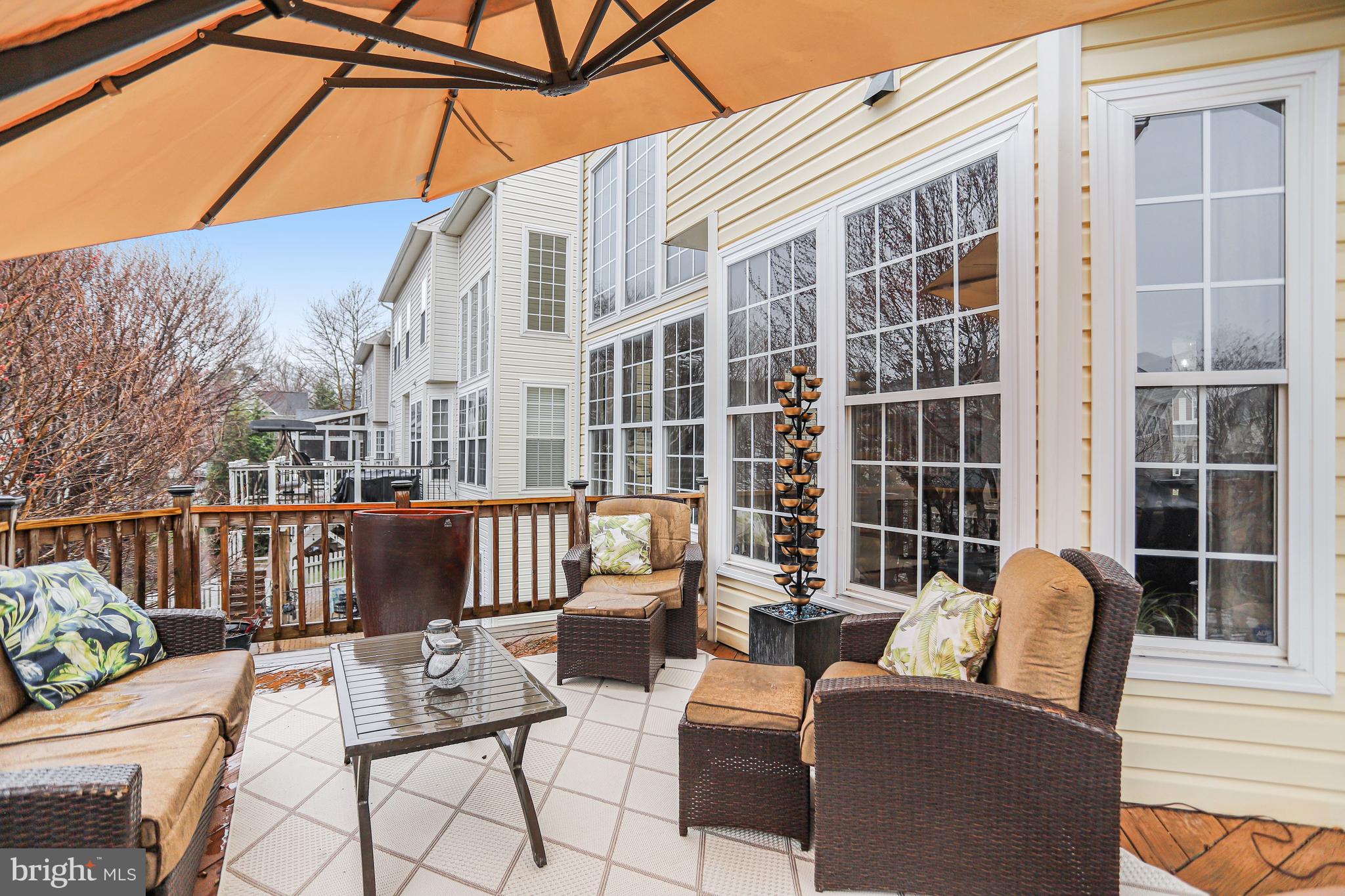 21625 Merion Street Ashburn, VA 20147 - Photo 79 of 80 a view of a patio with couches chairs and wooden floor