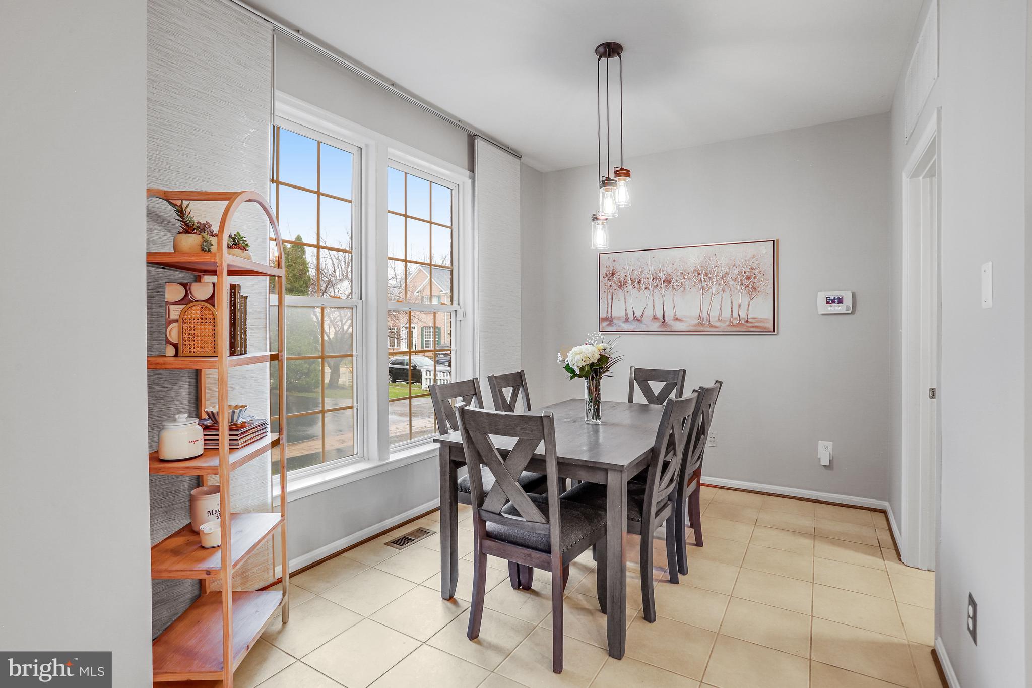 21625 Merion Street Ashburn, VA 20147 - Photo 8 of 80 a view of a dining room and livingroom with furniture wooden floor and a rug
