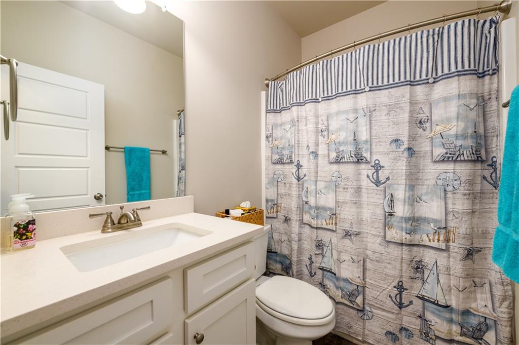3741 Highway 83 Good Hope, GA 30641 - Photo 11 of 60 a bathroom with a sink a toilet and shower curtain