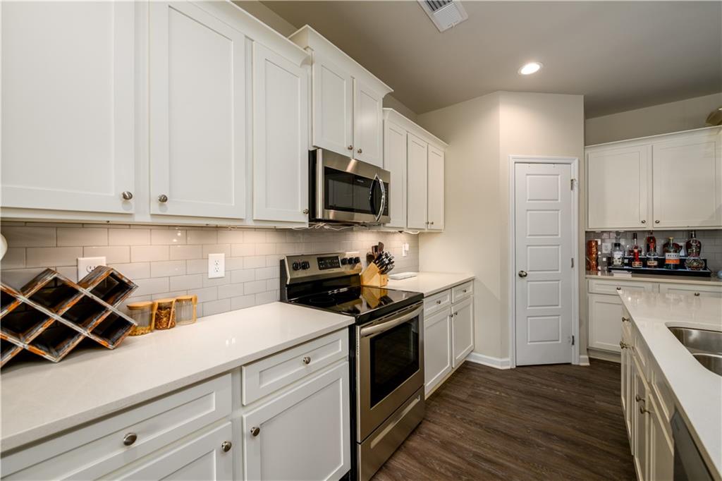 3741 Highway 83 Good Hope, GA 30641 - Photo 17 of 60 a kitchen with stainless steel appliances white cabinets sink and a stove