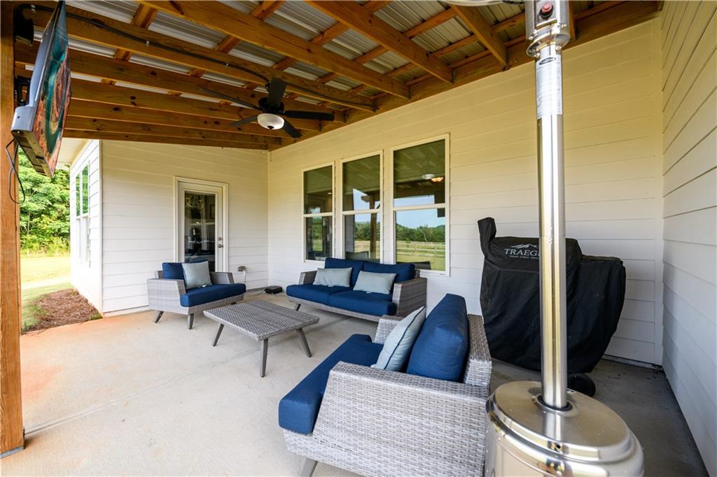 3741 Highway 83 Good Hope, GA 30641 - Photo 35 of 60 a living room with furniture a chandelier and a floor to ceiling window