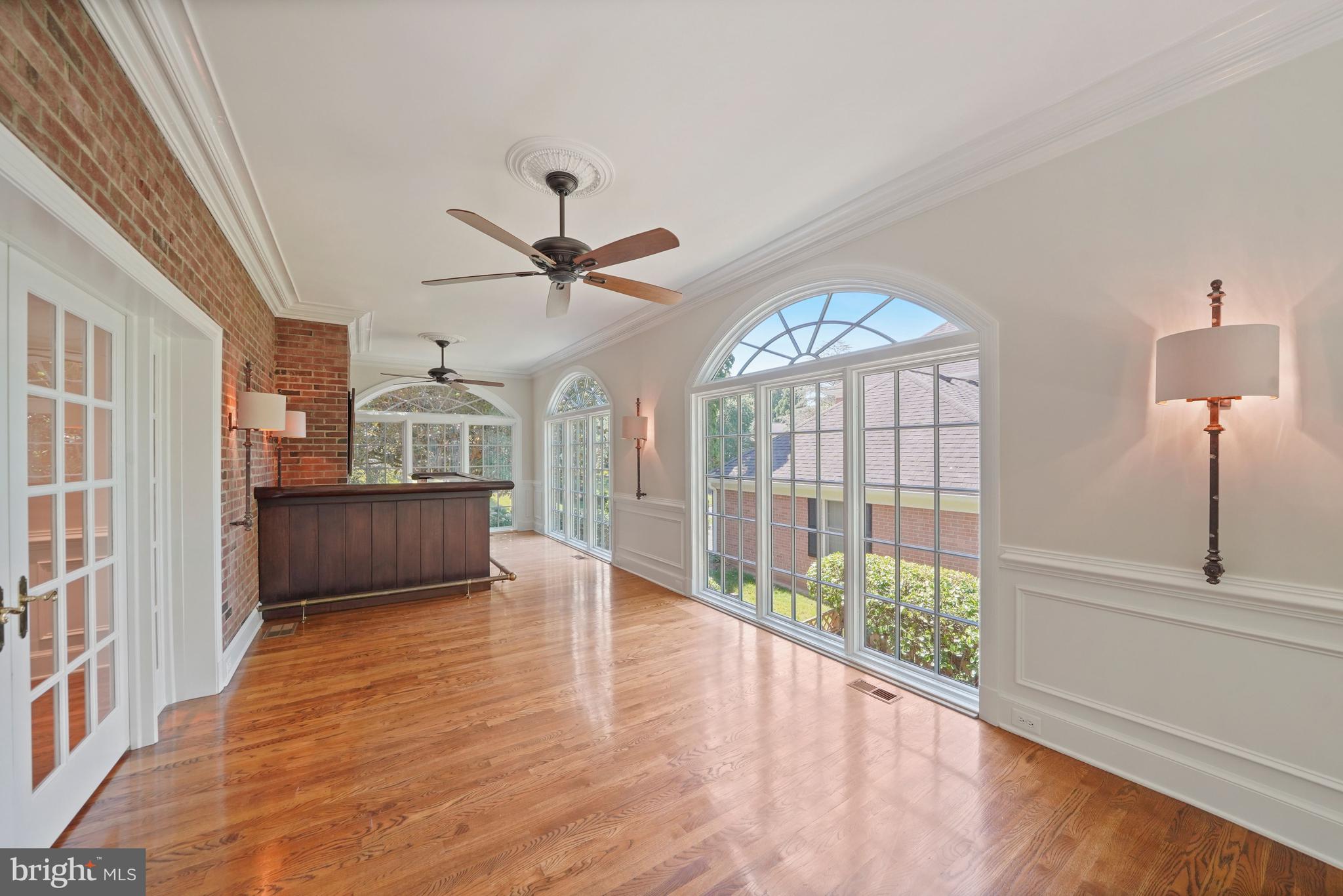 1226 Aldebaran Drive McLean, VA 22101 - Photo 11 of 40 a view of a livingroom with wooden floor a ceiling fan and windows