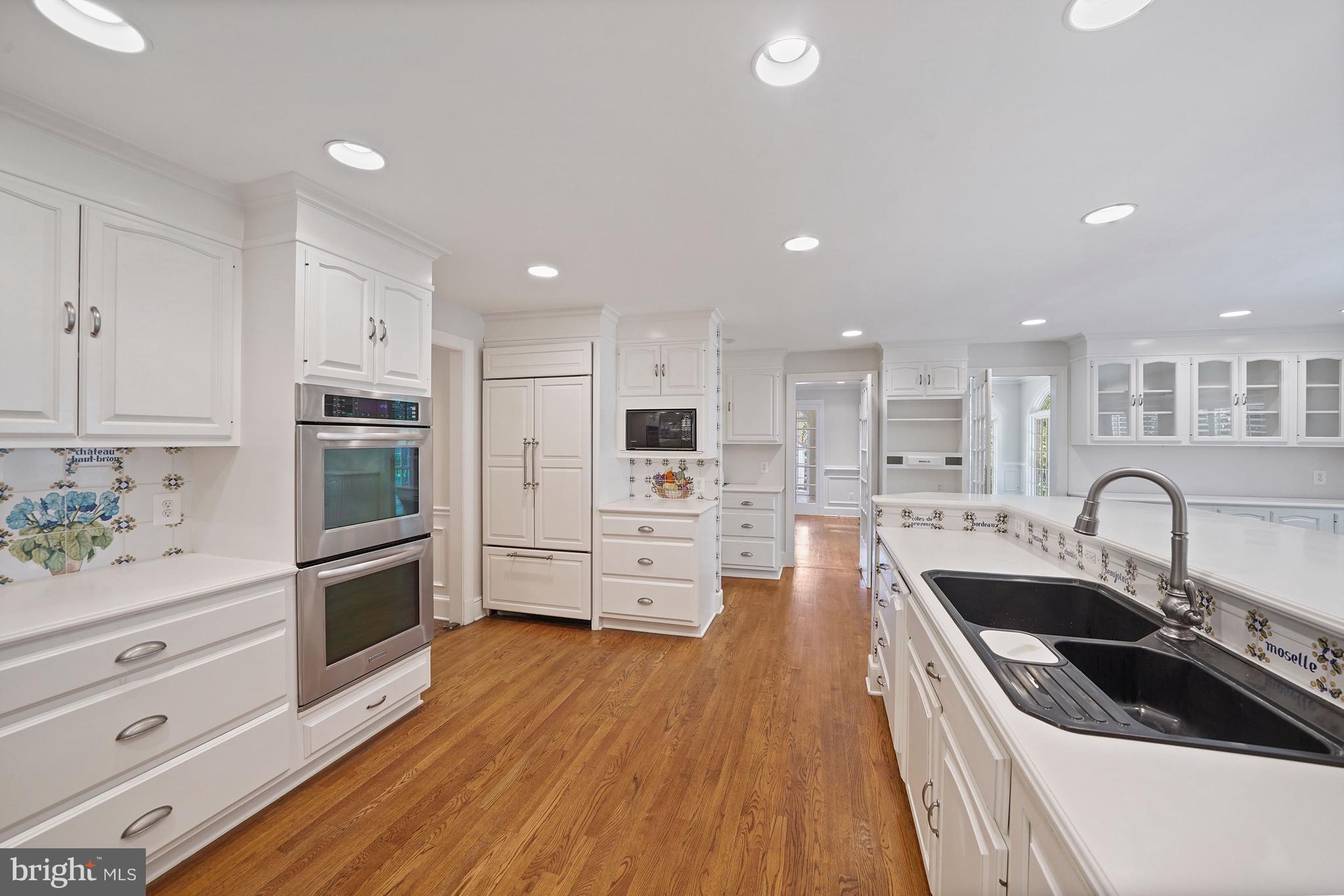 1226 Aldebaran Drive McLean, VA 22101 - Photo 13 of 40 a kitchen with stainless steel appliances a stove a sink a microwave a stove a refrigerator and cabinets