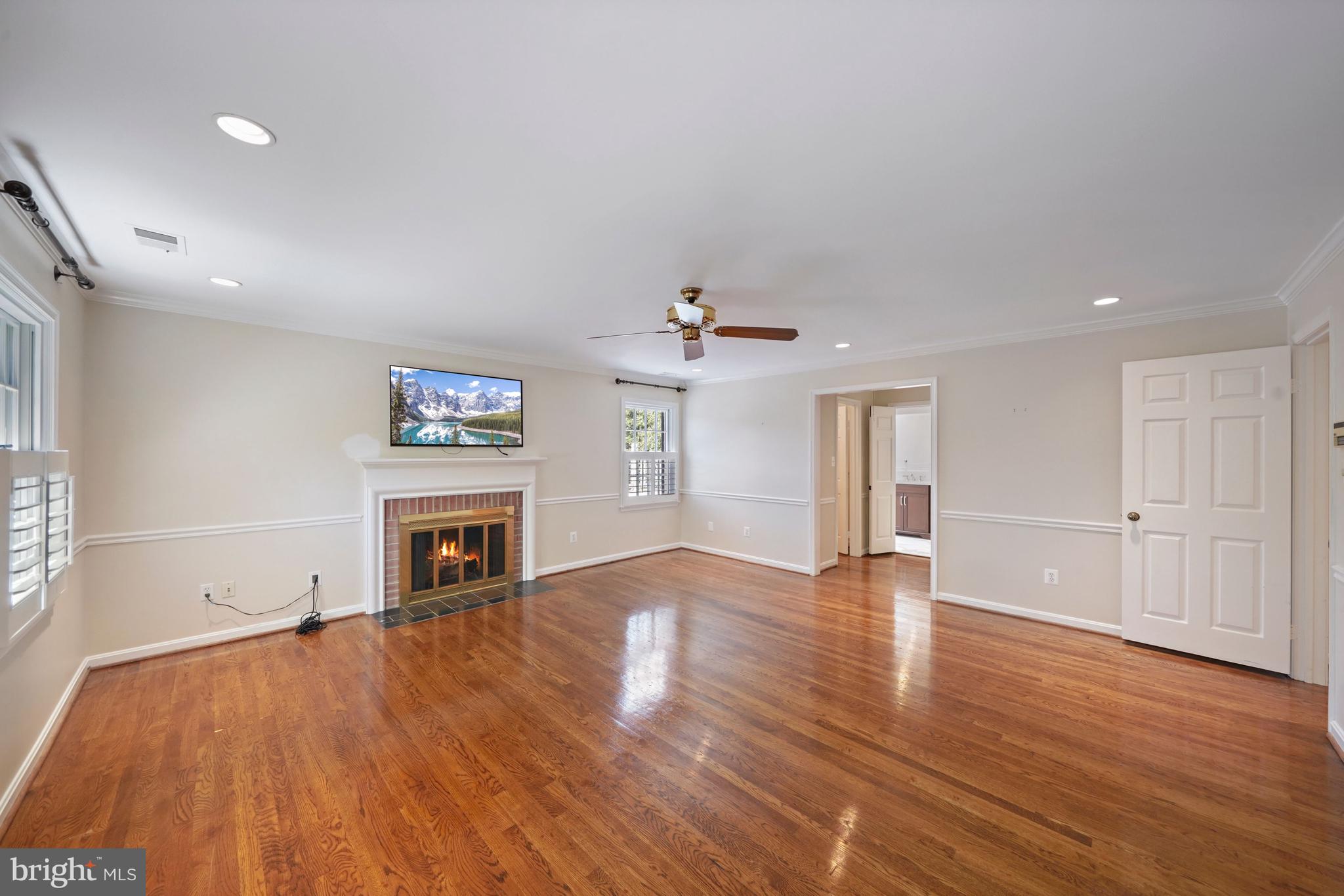 1226 Aldebaran Drive McLean, VA 22101 - Photo 19 of 40 a view of empty room with a fireplace and wooden floor