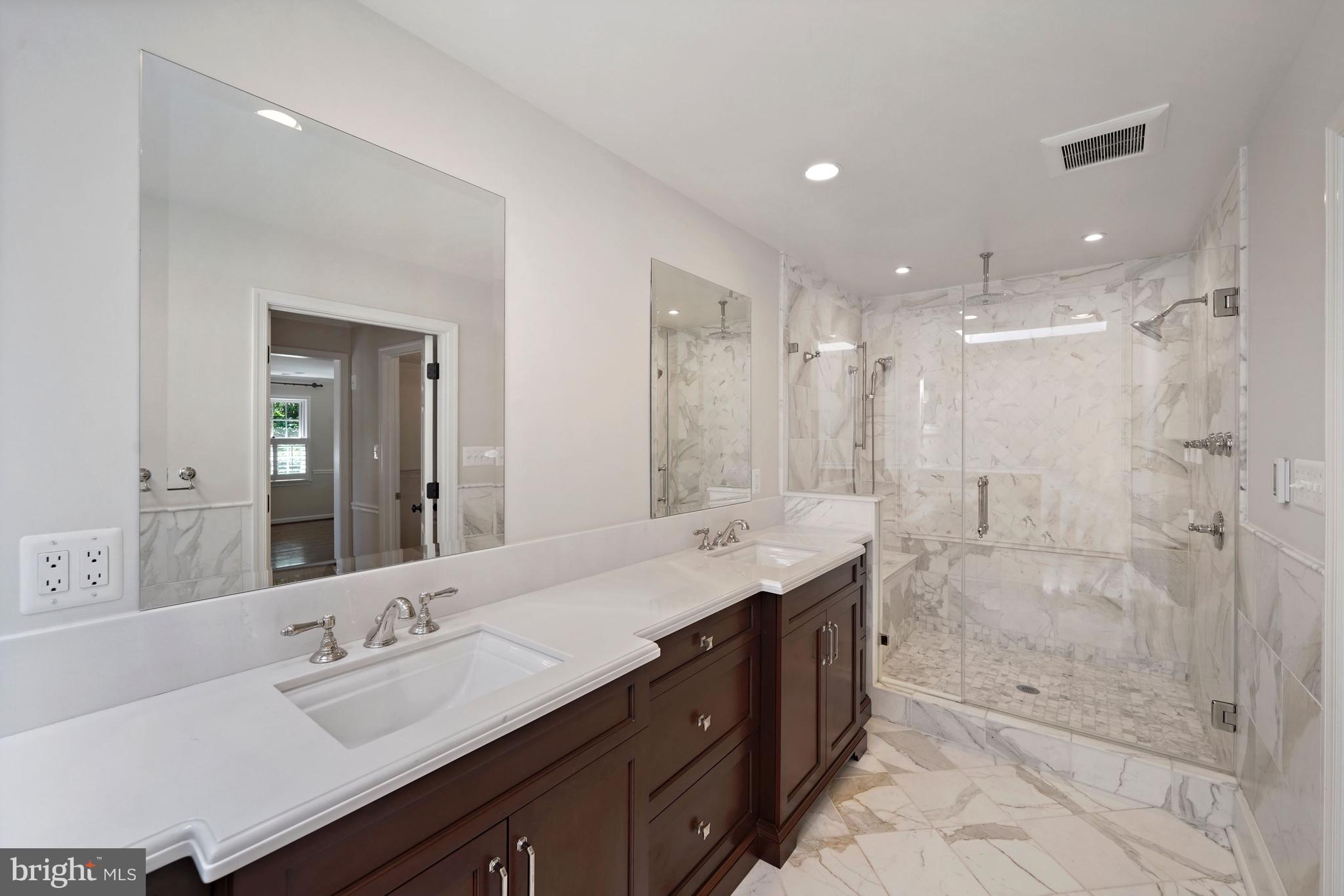 1226 Aldebaran Drive McLean, VA 22101 - Photo 20 of 40 a bathroom with a double vanity sink mirror double shower and a mirror
