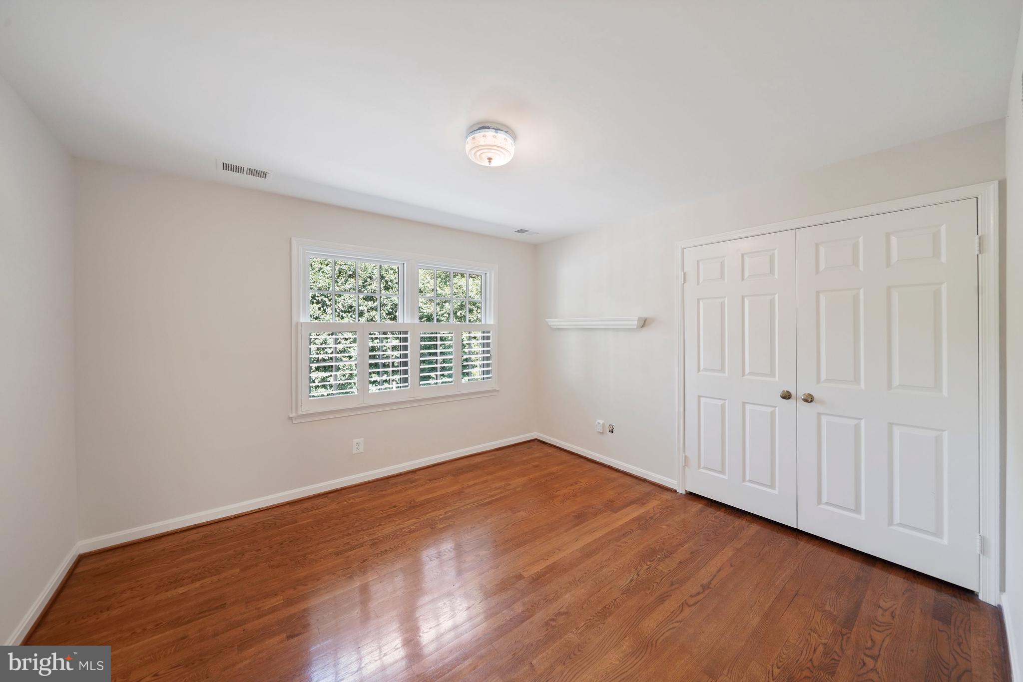 1226 Aldebaran Drive McLean, VA 22101 - Photo 22 of 40 a view of an empty room with wooden floor and a window