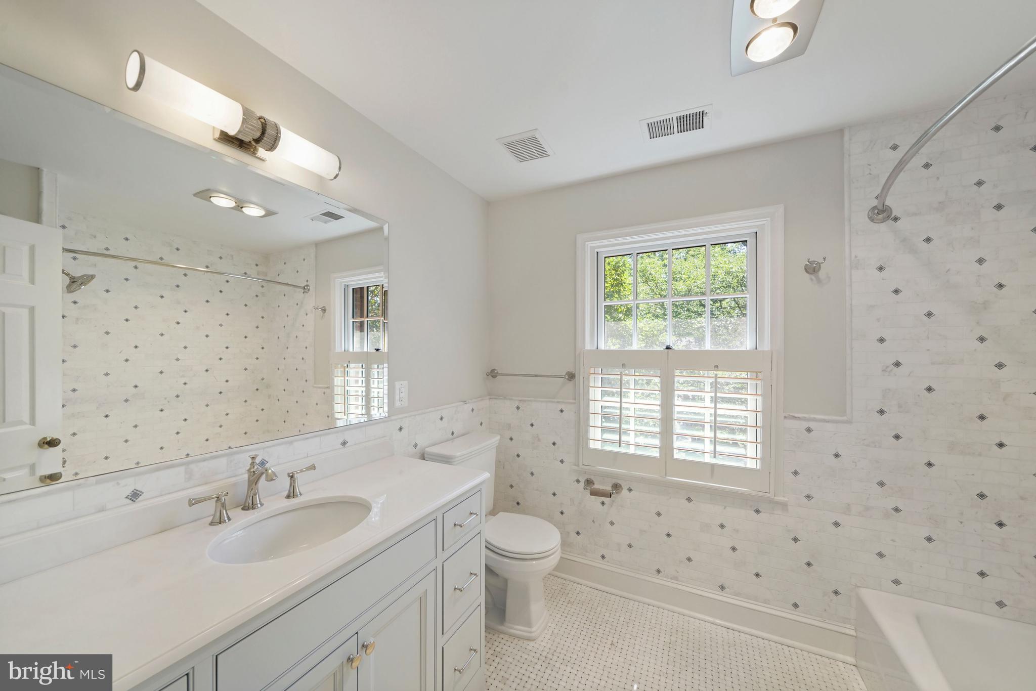 1226 Aldebaran Drive McLean, VA 22101 - Photo 23 of 40 a bathroom with a sink a toilet and a large mirror