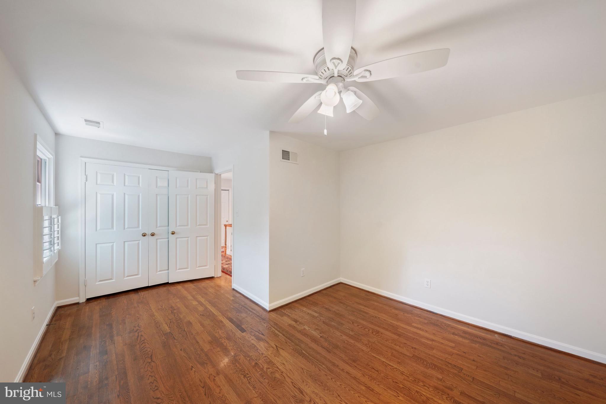 1226 Aldebaran Drive McLean, VA 22101 - Photo 24 of 40 an empty room with wooden floor and fan